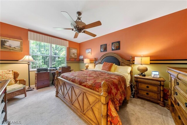 bedroom featuring light carpet and ceiling fan