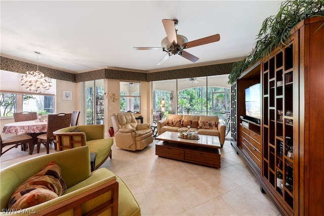 tiled living room with ceiling fan with notable chandelier