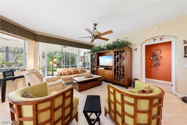 tiled living room featuring ceiling fan