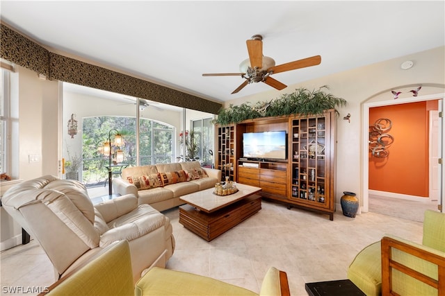 living room featuring light tile patterned floors and ceiling fan