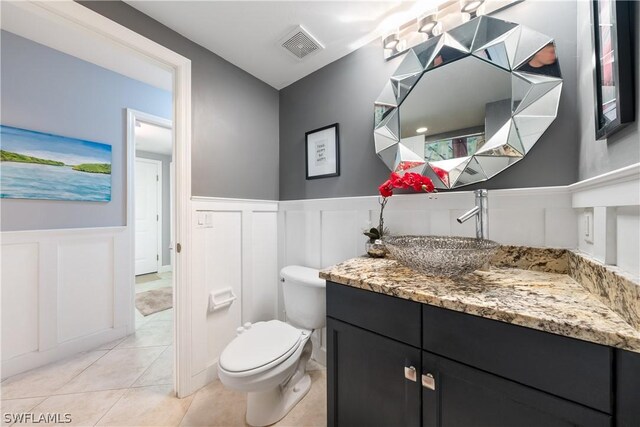 bathroom featuring tile patterned floors, toilet, and vanity