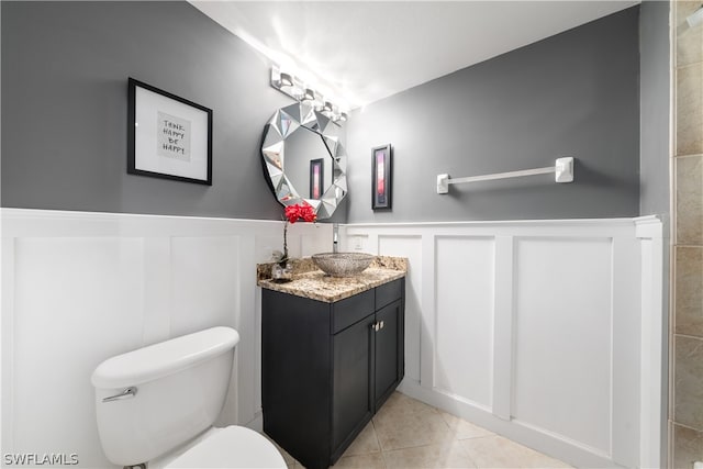 bathroom featuring tile patterned floors, vanity, and toilet