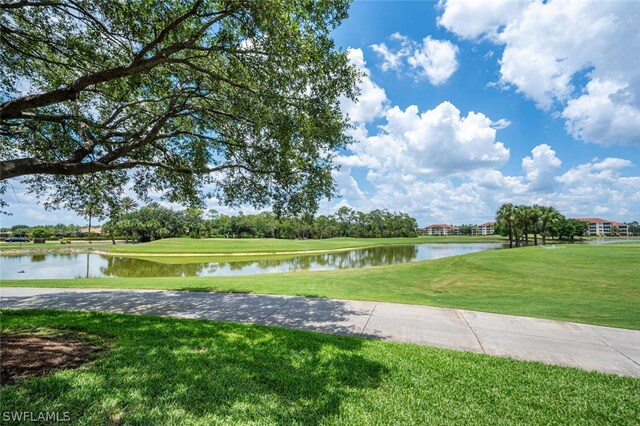 surrounding community featuring a water view and a yard