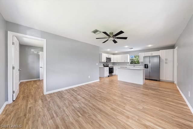 unfurnished living room with light hardwood / wood-style flooring and ceiling fan