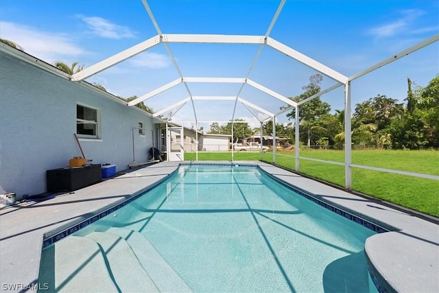 pool featuring a yard, a patio area, and glass enclosure