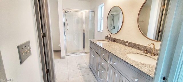 bathroom featuring vanity, tile patterned floors, and an enclosed shower