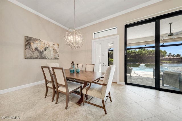 dining space with ceiling fan with notable chandelier, light tile patterned floors, crown molding, and french doors