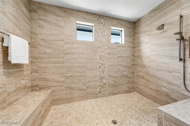 bathroom with tiled shower