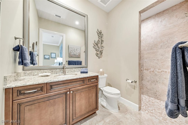 bathroom with crown molding, toilet, walk in shower, and vanity