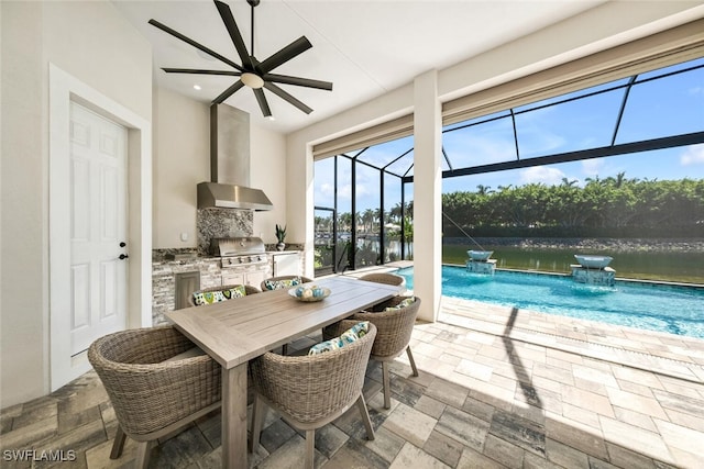 dining area featuring stone finish flooring, a water view, and a sunroom