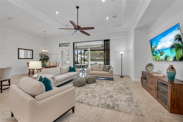 living area featuring recessed lighting, baseboards, and ceiling fan with notable chandelier