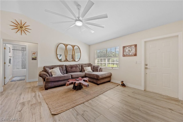 living room featuring lofted ceiling, ceiling fan, and light hardwood / wood-style flooring