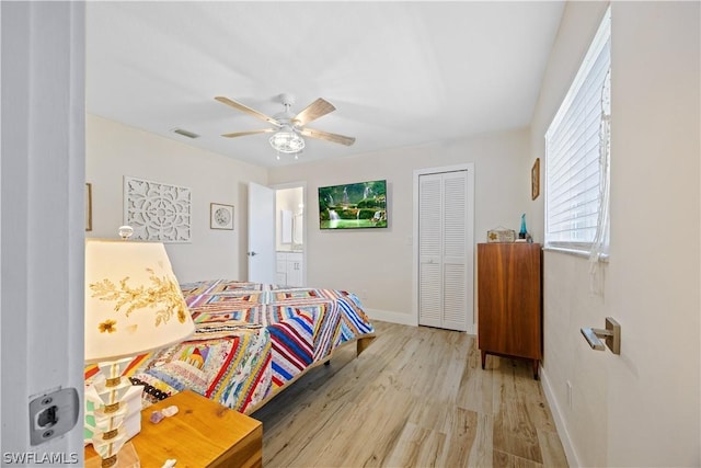 bedroom with ceiling fan, light hardwood / wood-style flooring, and a closet