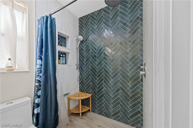 bathroom featuring a shower with shower curtain, toilet, and wood-type flooring