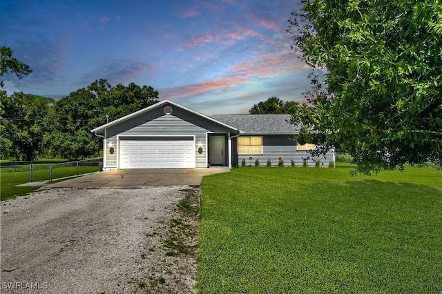 single story home with a lawn and a garage