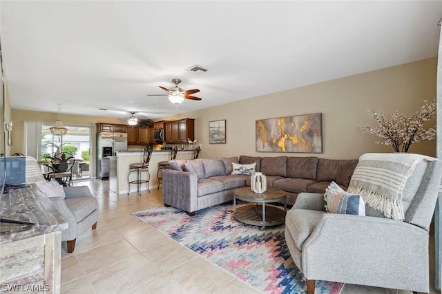 living room featuring ceiling fan and light tile patterned floors