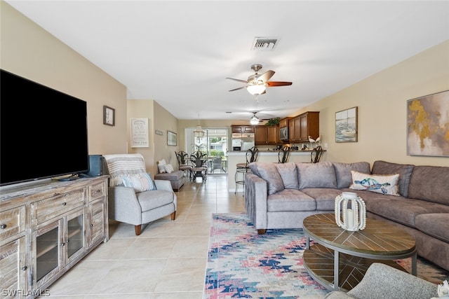 tiled living room featuring ceiling fan