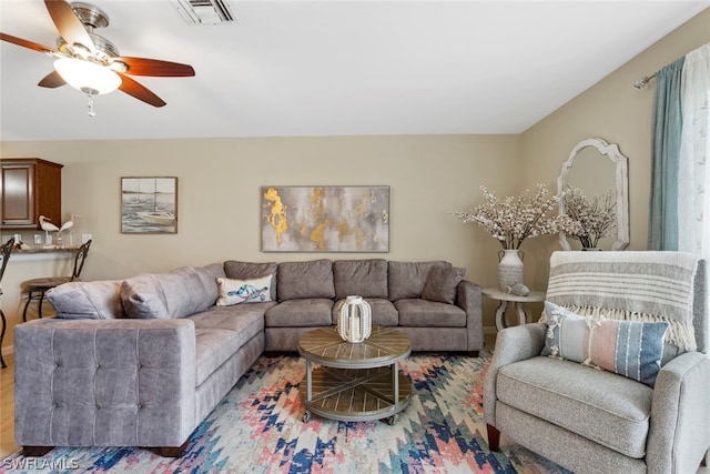 living room with ceiling fan and light hardwood / wood-style floors