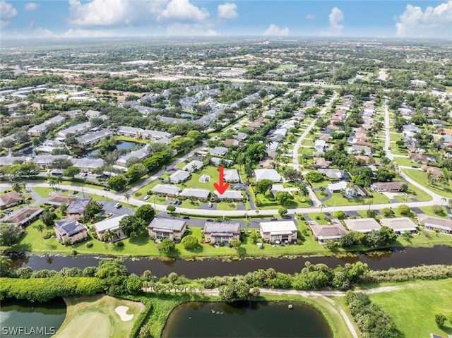 drone / aerial view with a water view and a residential view