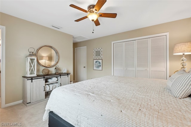 carpeted bedroom featuring ceiling fan and a closet