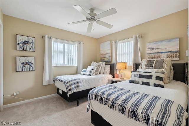 bedroom featuring ceiling fan and light colored carpet