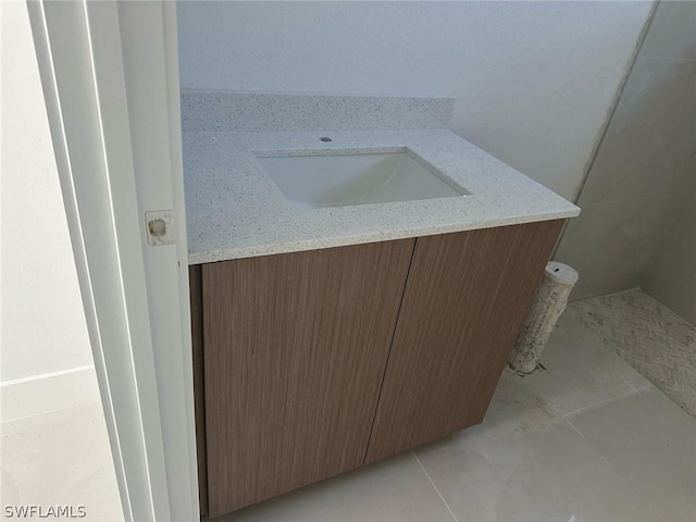 bathroom featuring tile patterned flooring and vanity