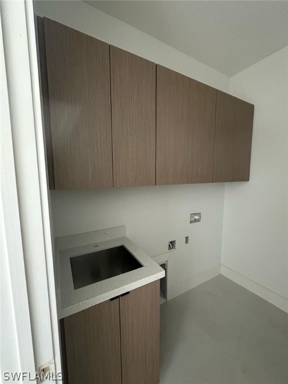 clothes washing area featuring cabinets and hookup for a washing machine