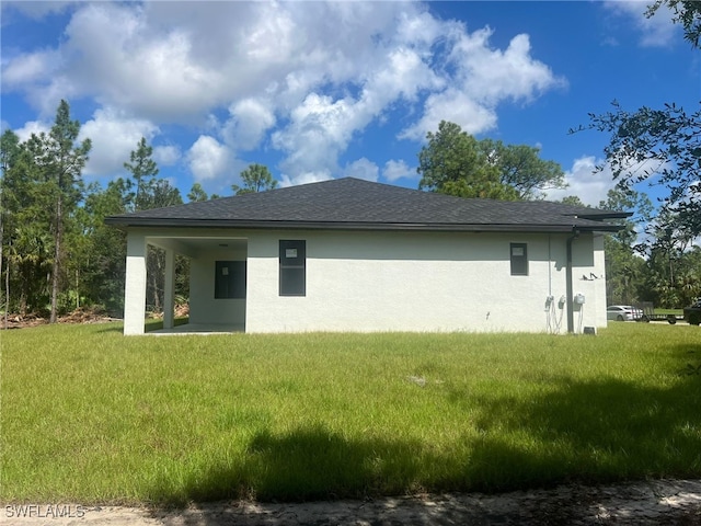 back of house with a lawn