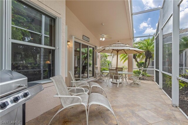 sunroom with a wealth of natural light, ceiling fan, and vaulted ceiling