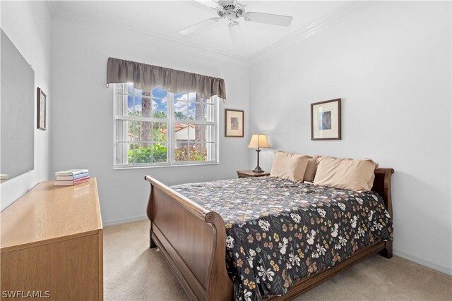 bedroom with crown molding, ceiling fan, and light colored carpet