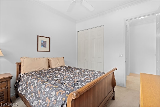 carpeted bedroom featuring crown molding, ceiling fan, and a closet