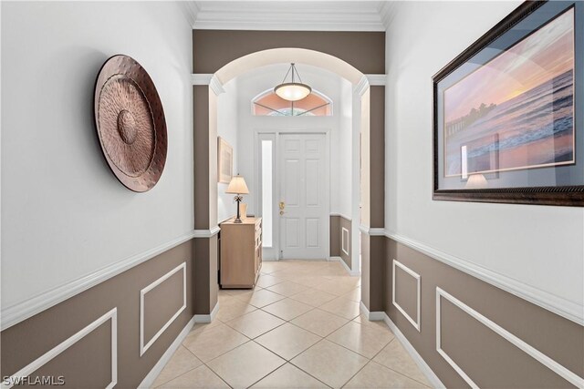 tiled entryway featuring ornamental molding