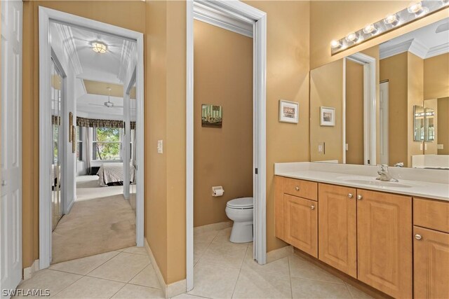 bathroom with tile patterned floors, toilet, ornamental molding, and vanity