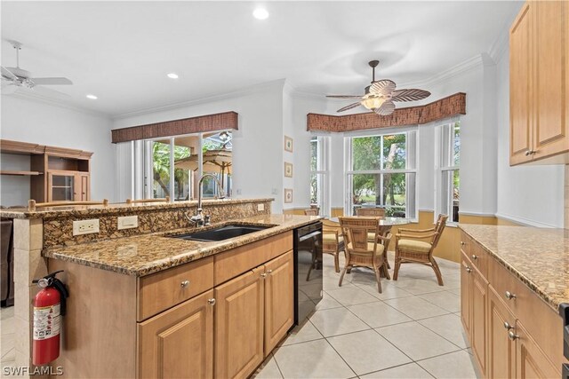 kitchen with ceiling fan, dishwasher, a kitchen island with sink, and sink