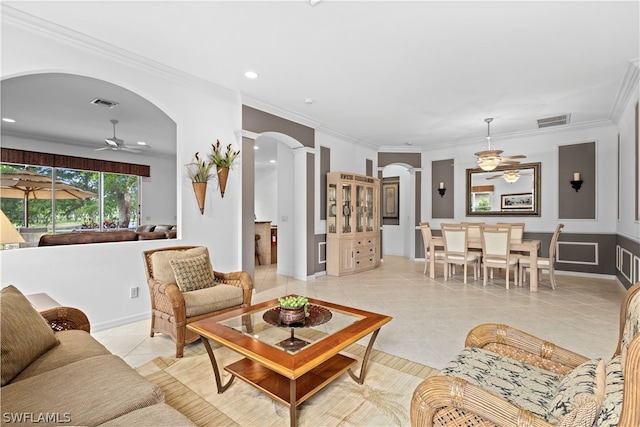 tiled living room featuring ceiling fan and crown molding