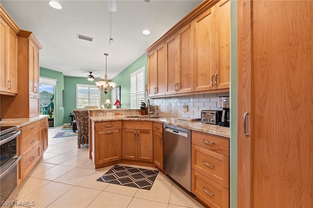 kitchen with stainless steel dishwasher, light tile patterned floors, tasteful backsplash, ceiling fan, and kitchen peninsula