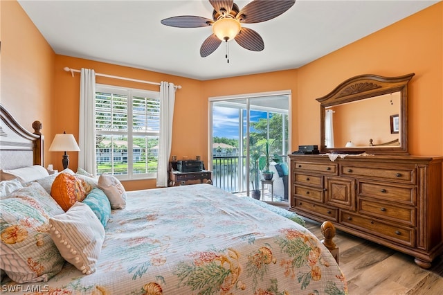 bedroom featuring access to exterior, multiple windows, ceiling fan, and light hardwood / wood-style flooring