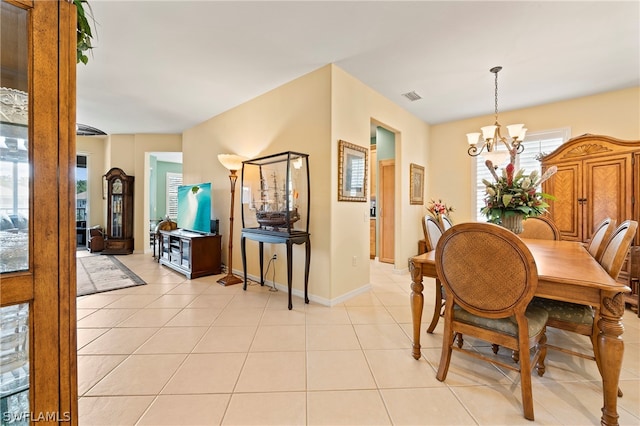 tiled dining room featuring a notable chandelier