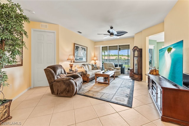 tiled living room with ceiling fan