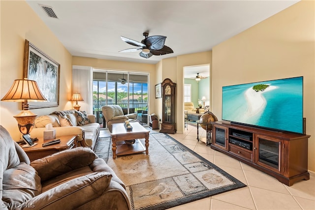 living room with light tile patterned floors and ceiling fan