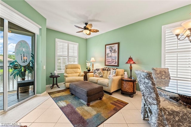 tiled living room with plenty of natural light and ceiling fan