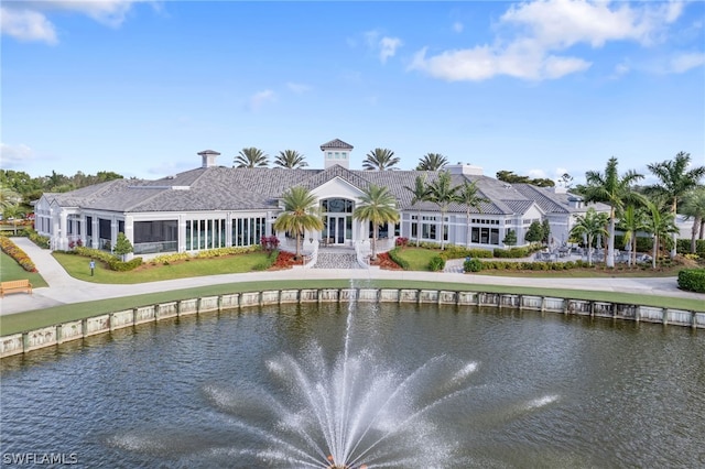 rear view of house featuring a water view