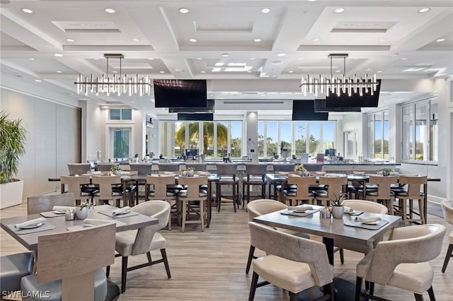 dining room with light hardwood / wood-style floors, coffered ceiling, and beamed ceiling