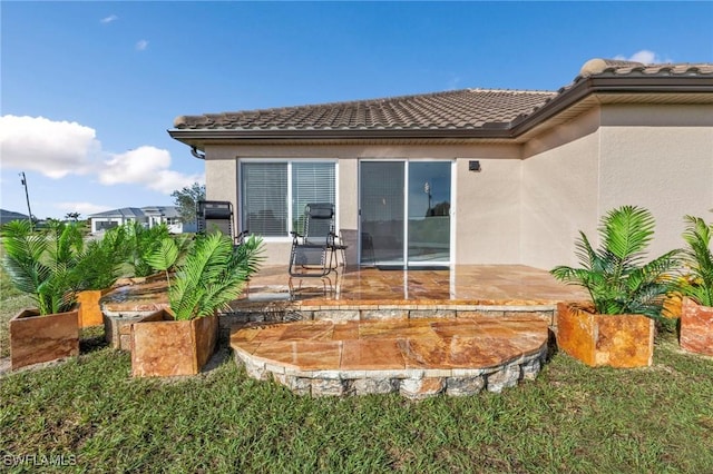 back of house with a patio area