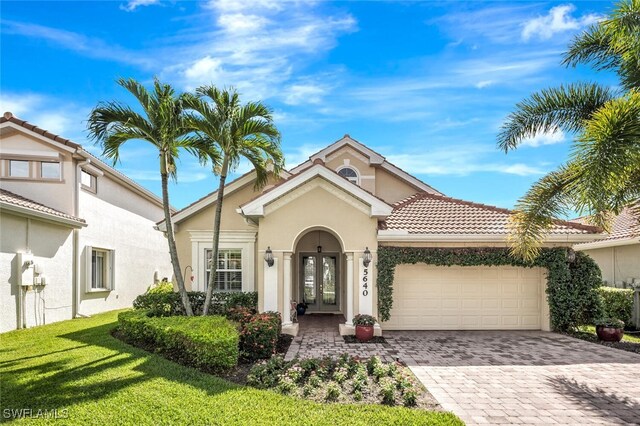 view of front of home featuring a garage and a front lawn