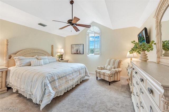 bedroom with ceiling fan, lofted ceiling, and light carpet