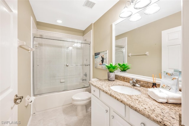 full bathroom featuring tile patterned floors, vanity, bath / shower combo with glass door, and toilet