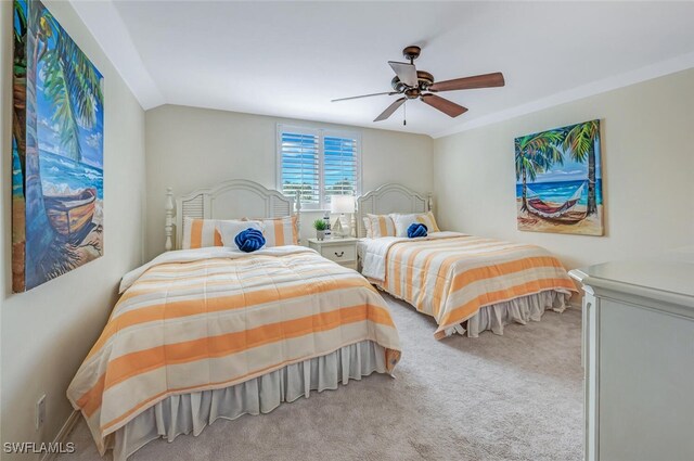 bedroom featuring ceiling fan, lofted ceiling, and light carpet