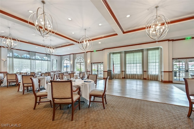 dining space with plenty of natural light, wood-type flooring, and crown molding