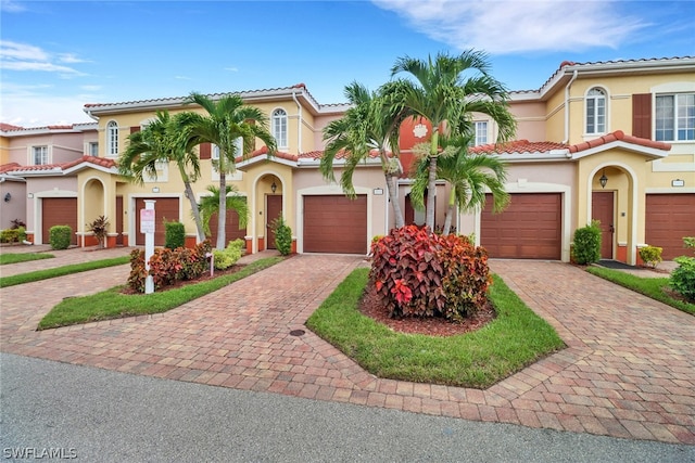 mediterranean / spanish-style house with a garage